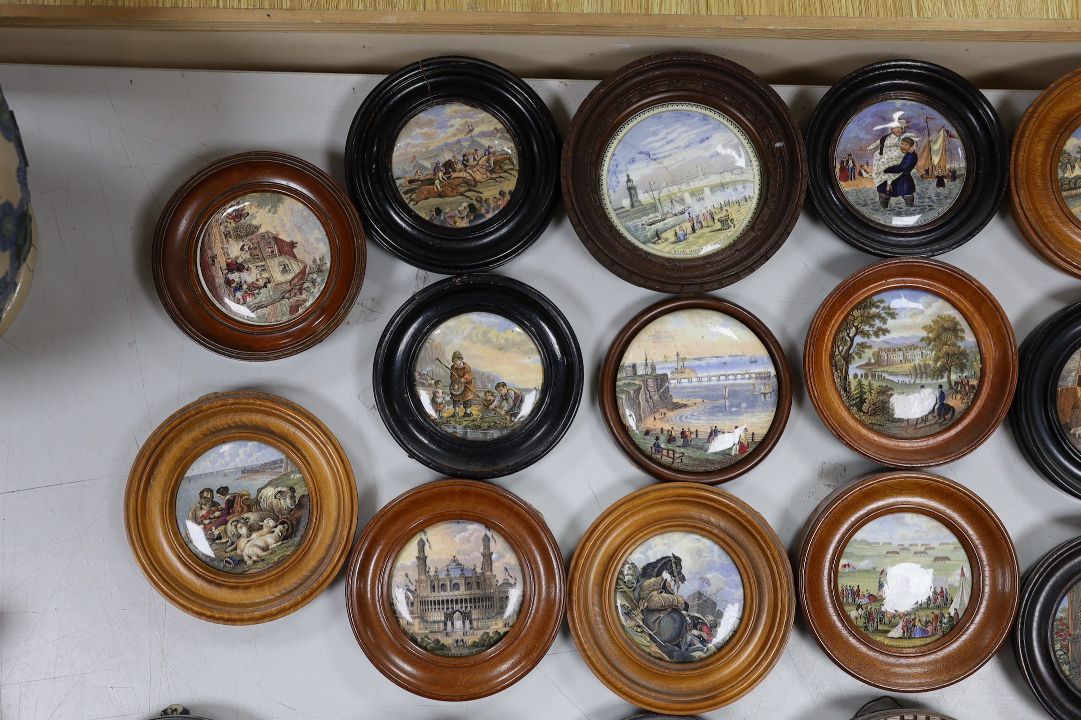 A collection of 19th century Prattware pot lids (23)